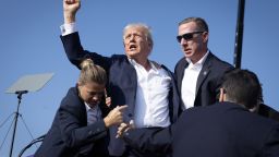 BUTLER, PENNSYLVANIA - JULY 13: Republican presidential candidate former President Donald Trump defiantly pumps his fist after being shot and rushed offstage during a rally on July 13, 2024 in Butler, Pennsylvania. Butler County district attorney Richard Goldinger said the gunman was shot and killed after injuring former U.S. President Donald Trump, killing one audience member and critically injuring two others in the shooting. (Photo by Anna Moneymaker/Getty Images)