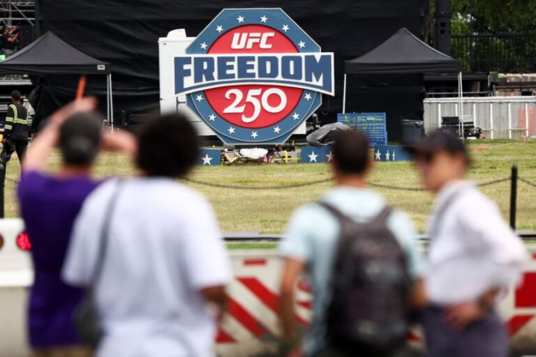People look at a sign of the UFC Freedom 250 fight card, near the White House in Washington, DC, US, June 9, 2026.