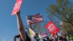 Demonstrators hold placards referencing the Fourteenth Amendment to the U.S. Constitution near the U.S. Capitol and the U.S. Supreme Court building as the court hears oral arguments on the legality of the Trump administration's effort to limit birthright citizenship for the children of immigrants, in Washington, D.C., U.S., April 1, 2026. REUTERS/Kylie Cooper