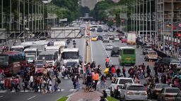 Pedestrians cross an avenue, after U.S. President Donald Trump said on Saturday that the airspace above and around Venezuela would be completely closed, amid rising tensions between the Trump administration and the government of Venezuelan President Nicolas Maduro, in Caracas, Venezuela, November 29, 2025. REUTERS/Gaby Oraa