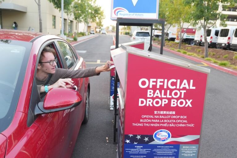 A person votes via the drive-thru drop box at the San Diego County Registrar of Voters office during California's primary election.
