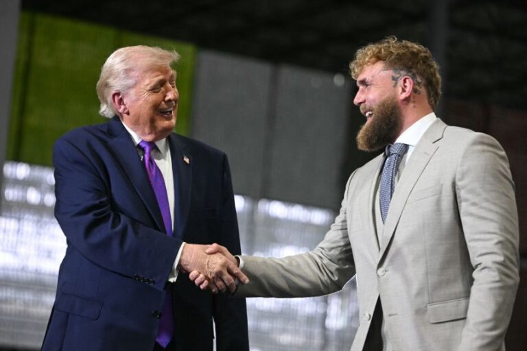 President Donald Trump shakes hands with US boxer and influencer Jake Paul during a rally at Verst Logistics in Hebron, Kentucky, on March 11, 2026.