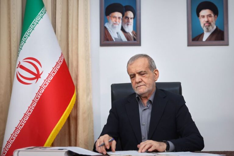 Iranian President Masoud Pezeshkian signs a memorandum of understanding in Tehran on June 18.