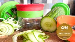 The Oxo Good Grips 3-Blade Handheld Spiralizer and a spiralized cucumber.