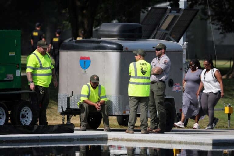 National Park Service employees look on as work continues at the Lincoln Memorial Reflecting Pool on the National Mall on June 25, 2026.