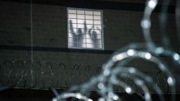 Detainees stand by a window inside the federal immigration center at Delaney Hall in Newark on May 26.