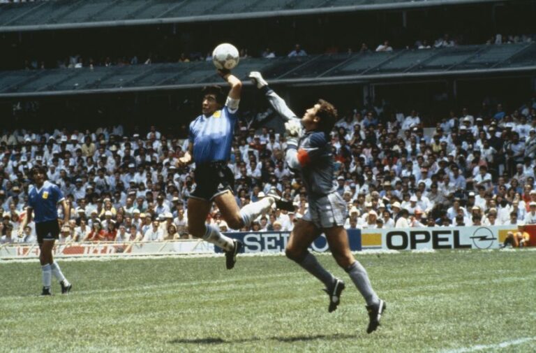 Argentina's Diego Maradona scores first goal with his Hand of God, past England goalkeeper Peter Shilton, during the World Cup Mexico Quarter Final on June 22, 1986.