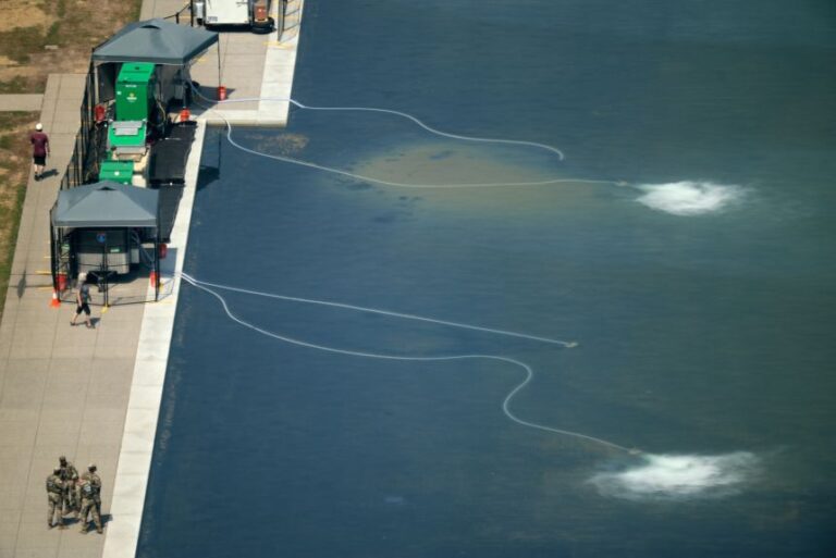 Machinery is deployed to counter an algae bloom on June 22.