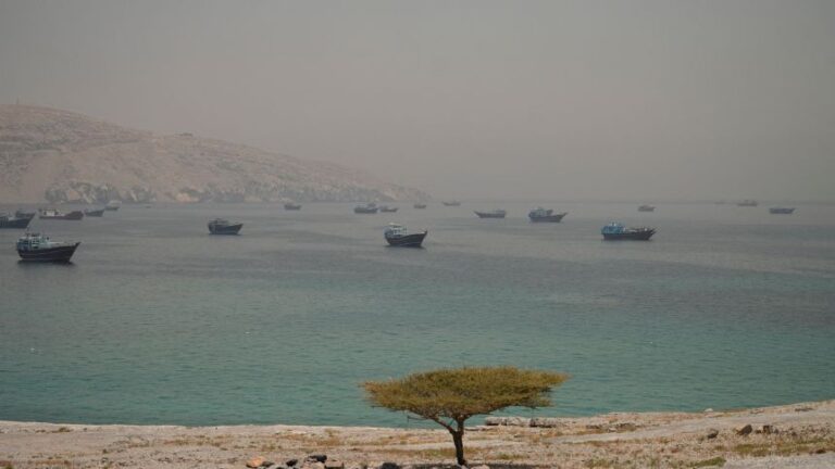 Vessels are anchored in the Strait of Hormuz, as seen from Musandam, Oman, on June 11, 2026.