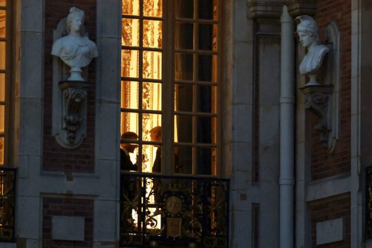 French President Emmanuel Macron and US President Donald Trump are silhouetted behind a window ahead of a dinner commemorating the 250th anniversary of the United States' independence, at the Palace of Versailles, near Paris, France, on Wednesday, June 17.