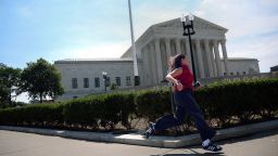 A reporter intern runs from the US Supreme Court as opinions are issued on June 25 in Washington, DC.