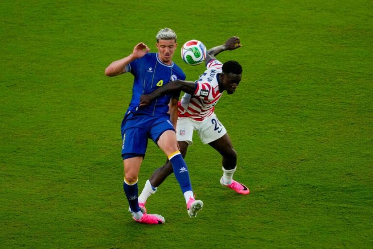 United States' Folarin Balogun fouls Bosnia's Tarik Muharemovic during the World Cup round of 32 soccer match between the United States and Bosnia in Santa Clara, California, on July 1. Balogun ultimately received a red card on the play.