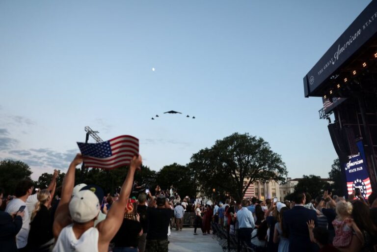 A US Air Force B-2 Spirit Stealth Bomber is flanked by four military aircrafts during a rally kicking off the Great American State Fair marking the 250th anniversary of U.S. independence on the National Mall in Washington, DC, on June 24, 2026.