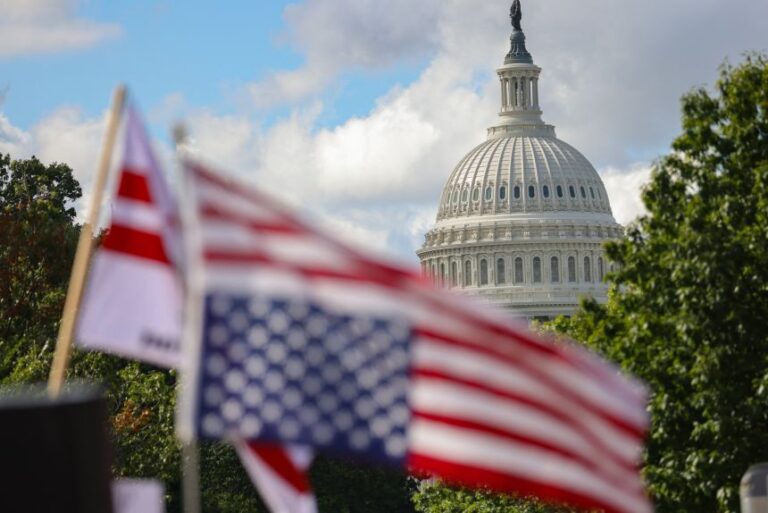 The dome of the US Capitol building is seen beyond an upside-down US flag during an anti-Trump protest at Union Station in Washington, DC, on September 2, 2025.