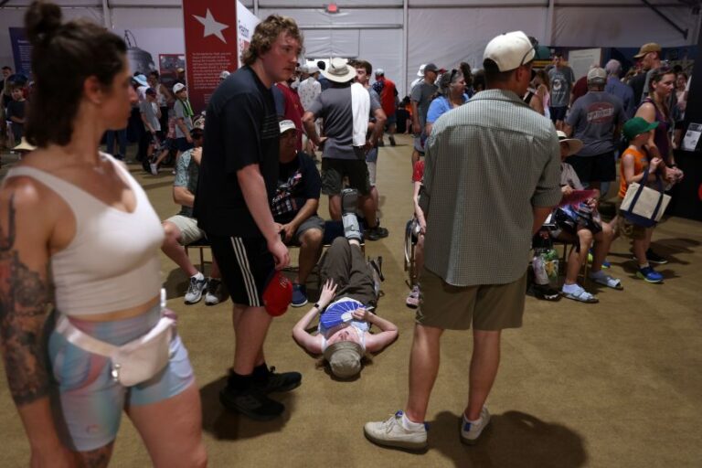 People take a break from the sun at the Great American State Fair on Friday, July 3.