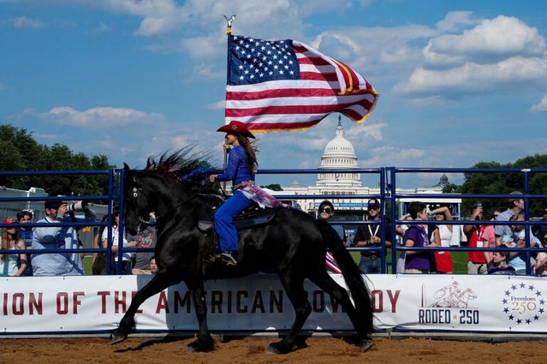 A woman on a horse carries a flag past the U.S. Capitol building during a rodeo at the opening of The Great American State Fair on the National Mall in Washington, DC, on June 25, 2026.