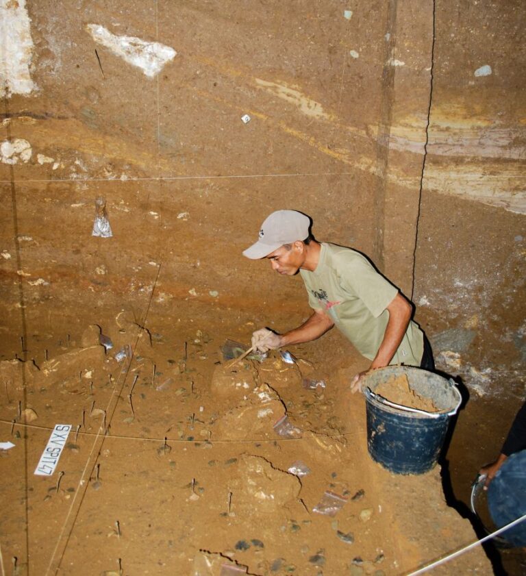 Excavation team member Benyamin Tarus works on Homo floresiensis deposits at the Liang Bua site.