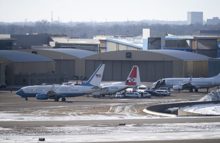 A plane from the US Presidential Airlift Fleet taxis before parking near an Eastern Air Express flight loaded with detainees at Minneapolis-St. Paul International Airport on January 11, 2026 in Minneapolis, Minnesota. The Department of Homeland Security has been running deportation flights out of the private charter Signature Aviation.