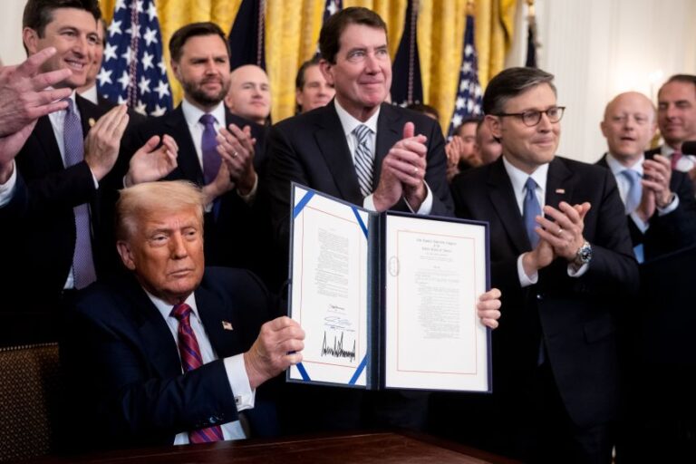 US President Donald Trump displays the signed bill during a signing ceremony for the GENIUS Act in the East Room of the White House in Washington, DC, on July 18, 2025. Trump signed the first federal bill to regulate stablecoins, hailing it as a