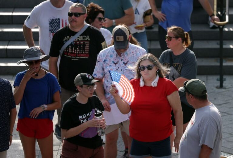 A tourist uses a fan while waiting to enter the US Capitol Building on Thursday in Washington, DC.