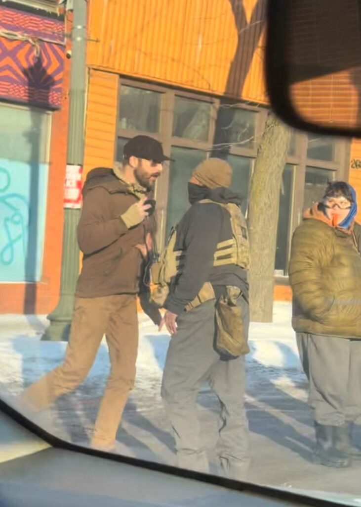A screengrab from a video obtained by Reuters shows Alex Pretti walking backwards on the street while holding a mobile phone near a law enforcement officer, moments before he was fatally shot on January 24.