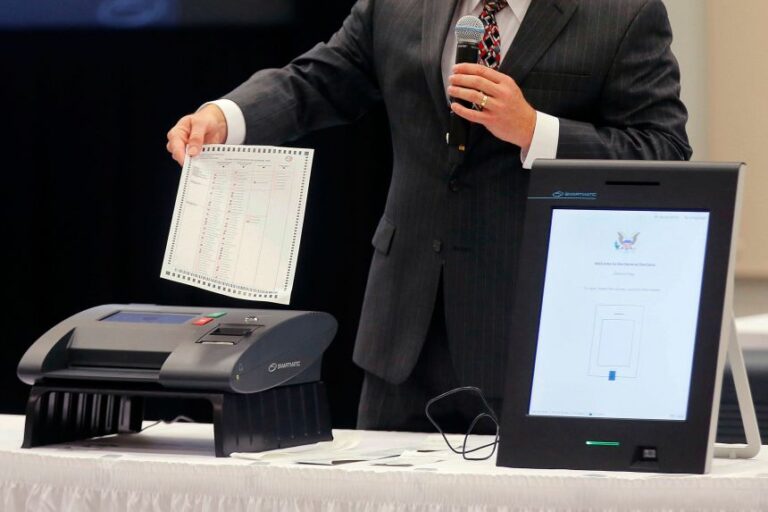 A Smartmatic representative demonstrates his company's system which has scanners and touch screens with printout options, at a meeting of the Secure, Accessible & Fair Elections Commission, August 30, 2018, in Grovetown, Georgia.