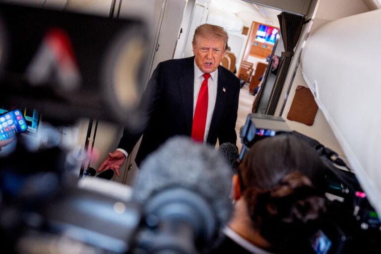 President Donald Trump speaks while aboard Air Force One for a trip to Michigan on July 27.