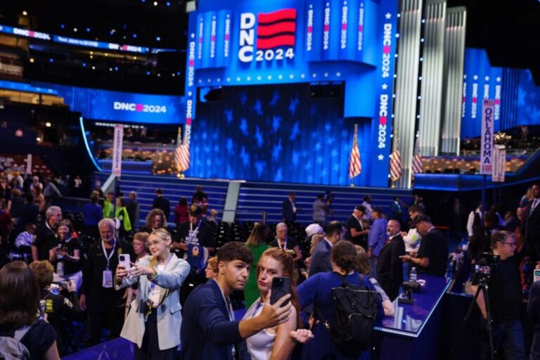 Influencers pose near the social media area of the Democratic National Convention in Chicago, Illinois, on August 20, 2024.