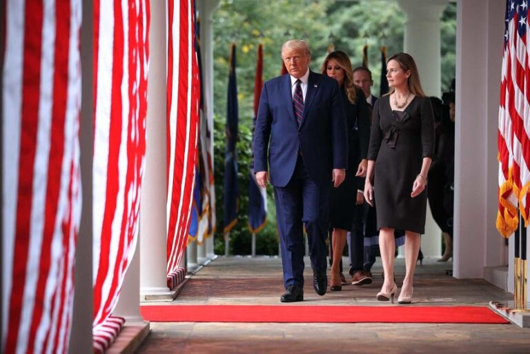 US President Donald Trump, first lady Melania Trump and 7th U.S. Circuit Court Judge Amy Coney Barrett, walk into the Rose Garden before Trump announces Barrett as his nominee to the Supreme Court at the White House September 26, in Washington.