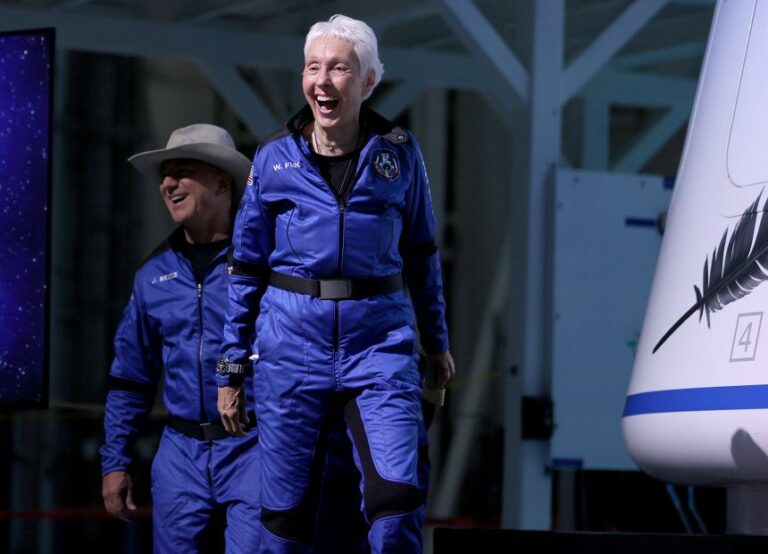 Blue Origin's New Shepard crew (L-R) Jeff Bezos and Wally Funk arrive for a press conference after flying into space in the Blue Origin New Shepard rocket on July 20, 2021 in Van Horn, Texas. Mr. Bezos and the crew were the first human spaceflight for the company.