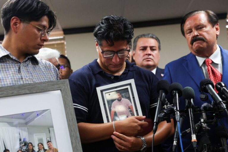 Ronaldo Salgado holds a photograph of his father, Lorenzo Salgado Araujo, who was fatally shot by an ICE agent, during a news conference, in Houston, Texas, on July 8, 2026.