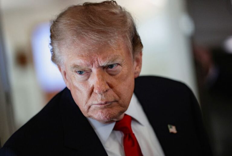 President Donald Trump speaks to reporters aboard Air Force One, en route to Michigan, on July 27.