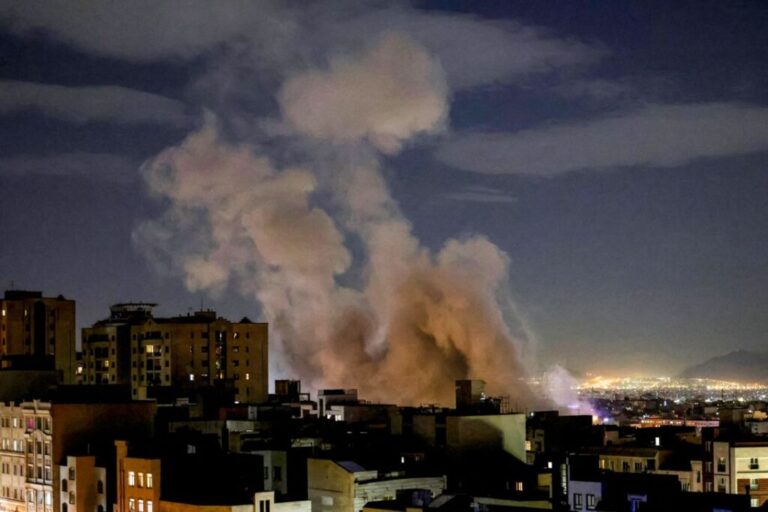A smoke plume rises following a missile strike on a building in Tehran on March 1, 2026.