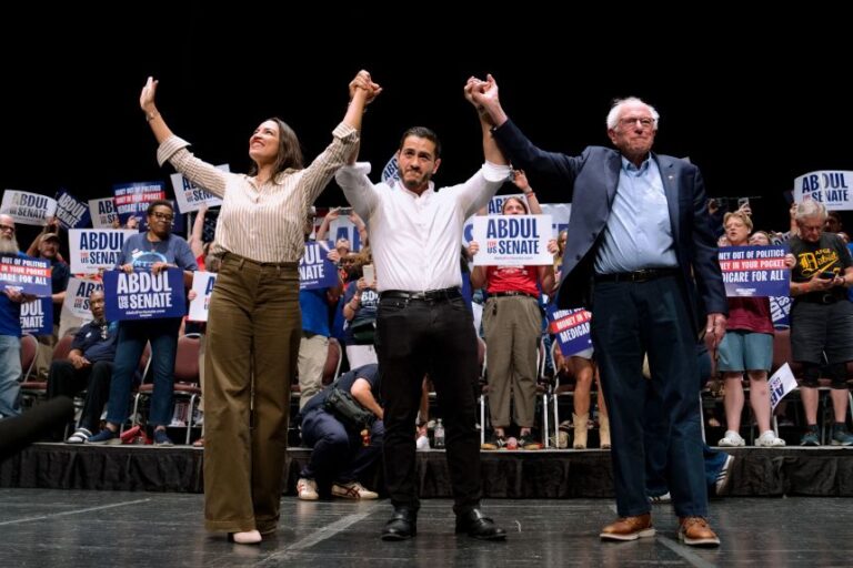 Representative Alexandria Ocasio-Cortez, Abdul El-Sayed, and Senator Bernie Sanders on stage during the
