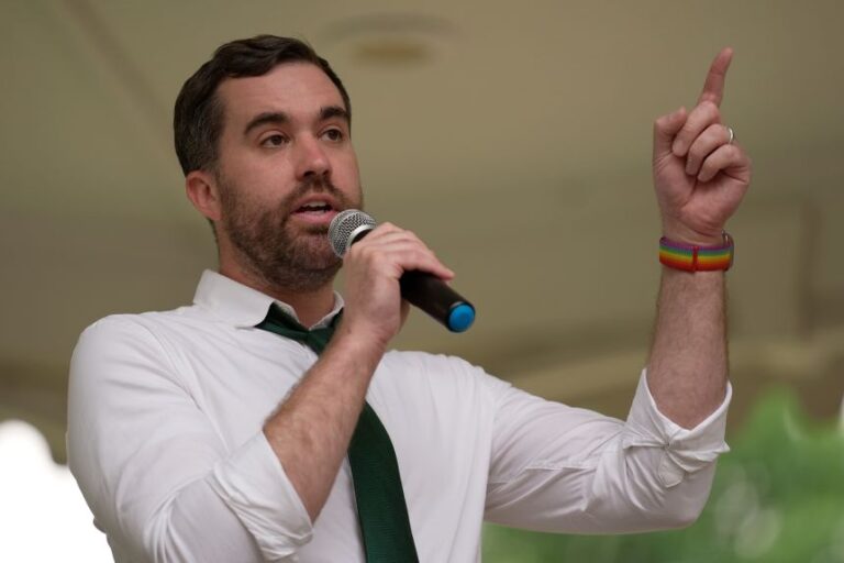Jordan Woods, a Democratic candidate for US Senate, speaks at a vigil in Lewiston, Maine, on Tuesday a day after the shooting of a man by US Immigration and Customs Enforcement.
