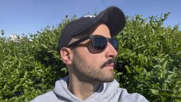 man wearing sunglasses and a baseball cap outside