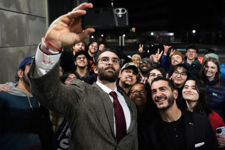 Streamer Hasan Piker, left, and Abdul El-Sayed take a selfie with young fans following a campaign event at the University of Michigan in Ann Arbor, on April 7.