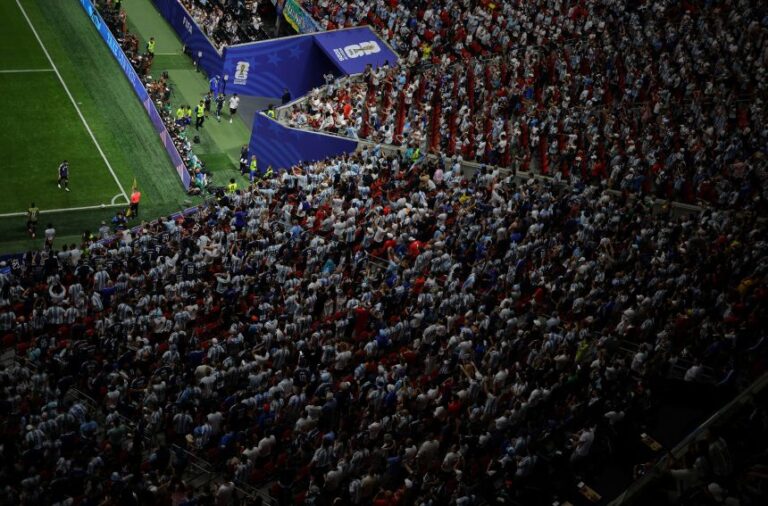 Argentina fans in the stand look on as Lionel Messi walks over to take a corner kick during the FIFA World Cup 2026 semifinal match between England and Argentina, in Atlanta, Georgia, on July 15, 2026.