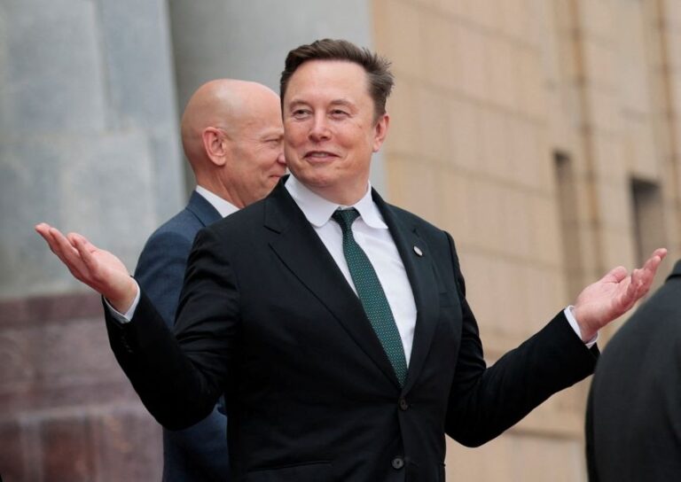 Elon Musk gestures leaves after attending a welcome ceremony for US President Donald Trump with Chinese President Xi Jinping at the Great Hall of the People in Beijing on May 14, 2026.