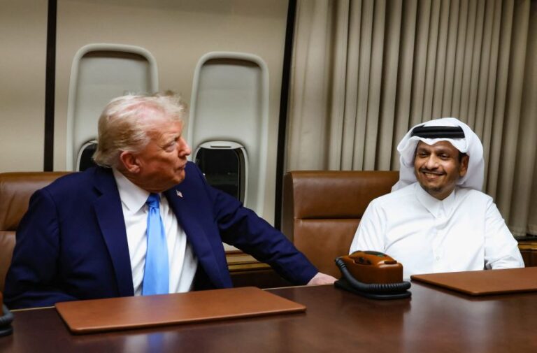 President Donald Trump speaks with Qatar's Foreign Minister Sheikh Mohammed bin Abdulrahman bin Jassim Al-Thani during a meeting on Air Force One during a refuelling stop at Al Udeid Air Base near Doha, Qatar, on October 25, 2025.