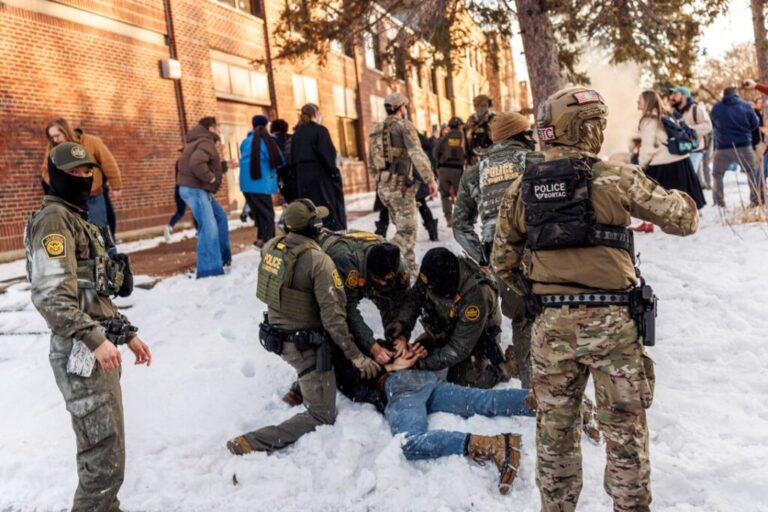 US Border Patrol agents detain a person near Roosevelt High School in Minneapolis, on January 7.