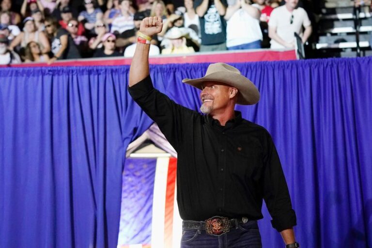 Pinal County sheriff Mark Lamb waves to a cheering crowd at a political rally in Prescott, Arizona, in July 2022.