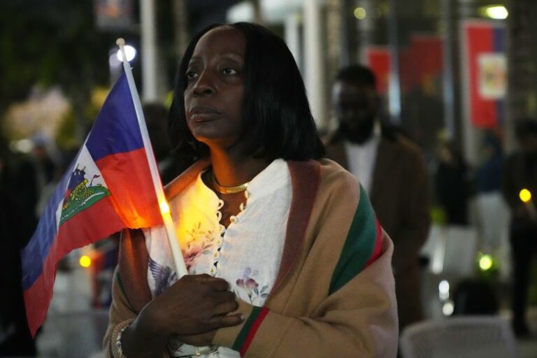 Linda Joseph holds a candle during a vigil at the Little Haiti Cultural Complex after a federal judge temporarily blocked the Trump administration from ending TPS, on February 3, 2026 in Miami.