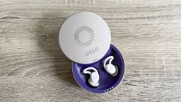 Ozlo Sleepbuds sitting on a table in the case.