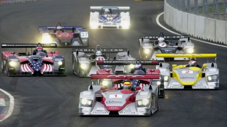 Cars race during the American Le Mans Series' inaugural Washington Grand Prix, on July 21, 2002.