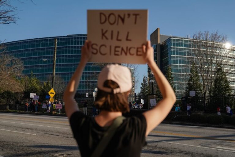 People protest personnel cuts at the US Centers for Disease Control and Prevention in Atlanta on March 12, 2025.