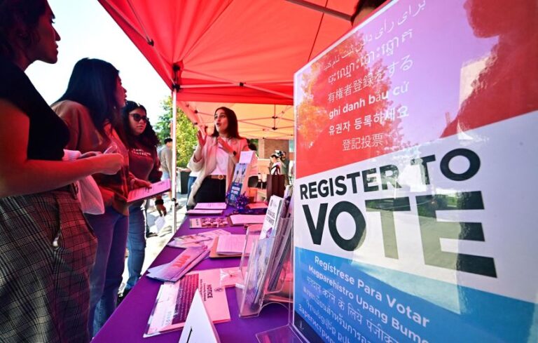 Potential young voters get information at a voter registration desk at Voter Fest 2024, an event designed to engage young voters and historically underserved communities on October 22, 2024 at Cal State Los Angeles in Los Angeles.