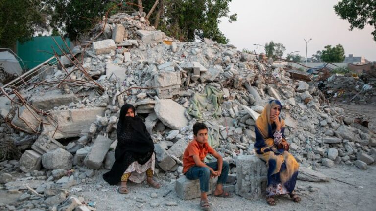 TEHRAN, IRAN - MAY 13: Two women and a child sit in ruins during their visit to Al-Shajara Al-Tayyiba School on May 13, 2026 in Tehran, Iran. On 28 February this year, a US military launched a missile strike that destroyed the all-girls Al-Shajara School in Minab, Iran, killing 175 people, including 47 schoolgirls and 26 teachers and causing global outrage. The attack is the deadliest civilian event of the 2026 Iran war. US investigators later stated American forces hit the school by mistake due to outdated intelligence, as the civilian school sat right next to an Iranian naval base. (Photo by Majid Saeedi/Getty Images)