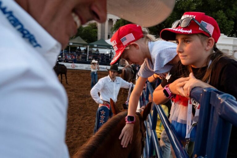 Charlotte Thompson, 8, pets a horse at The Great American State Fair on the National Mall, June 29.