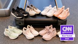 Eight running shoes placed around a treadmill in a gym.